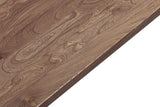 Close-up of the Bominaco top in Brown: a crisp square edge and a wavy grain with small dark knots