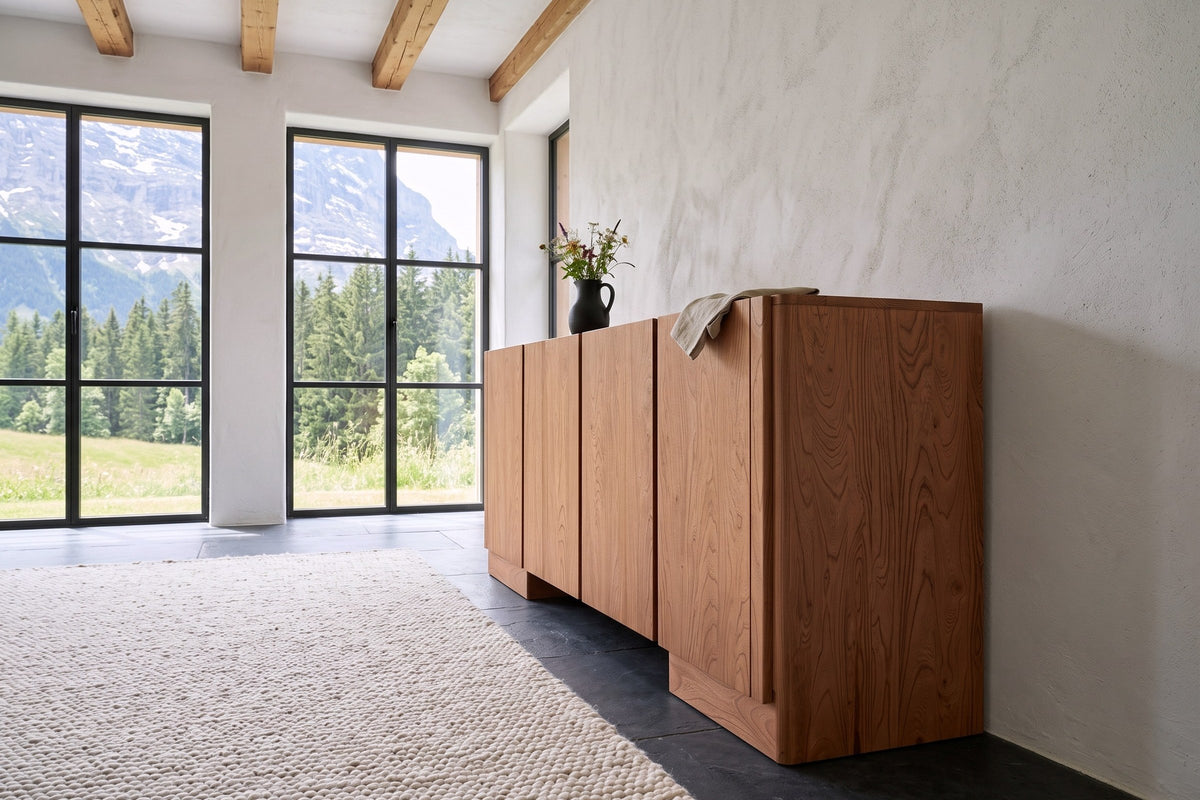 Bominaco sideboard in Brown seen from the end against lime plaster in a Grindelwald chalet