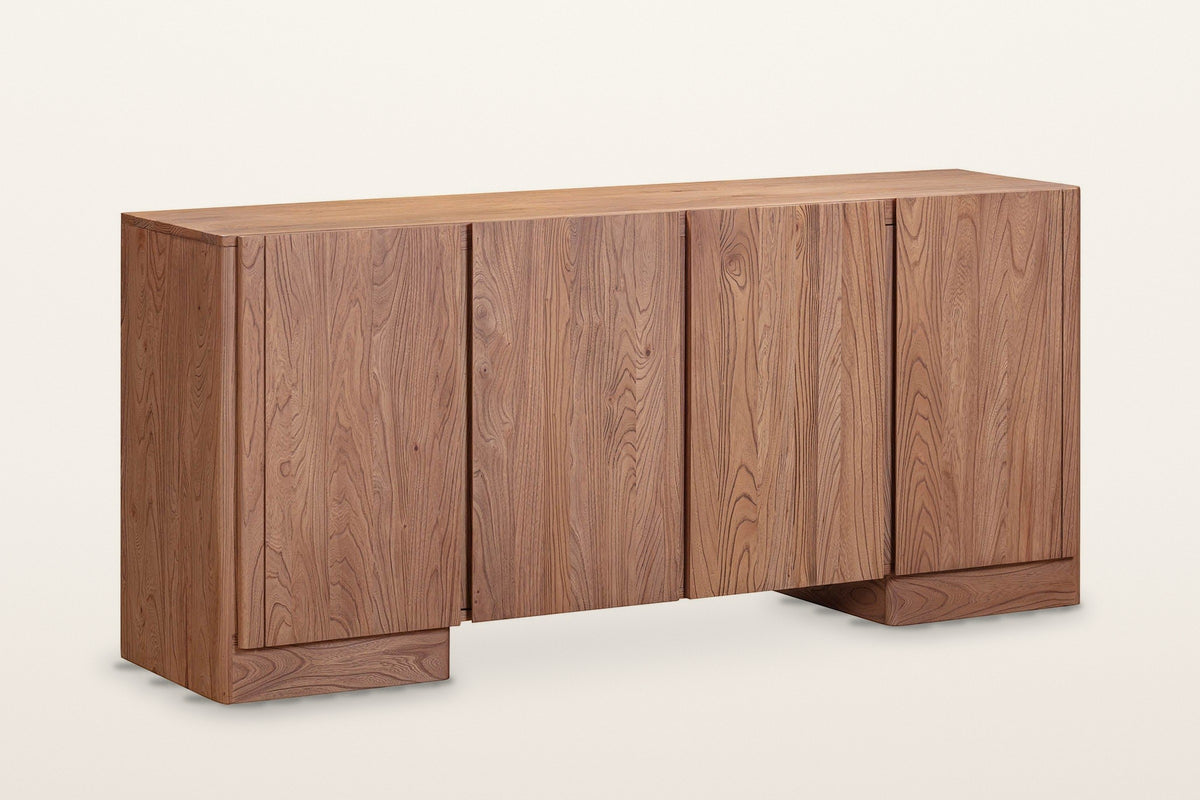 Bominaco wood sideboard in Brown, three-quarter view on a warm white studio backdrop: four plain slab doors with no handles