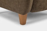 Close-up of a tapered solid birch leg in a teak finish under the velvet corner