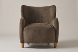 Bormio wingback chair in dark brown velvet, straight front view on a studio backdrop