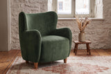 Bormio chair against an old limestone wall with snow outside the window, on wide pine floorboards (Olive Green)