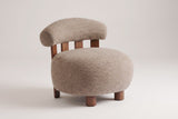 Brescia boucle accent chair in Light Brown, three-quarter view on a warm light-grey studio backdrop