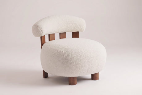 Brescia boucle accent chair in Off White, three-quarter view on a warm light-grey studio backdrop