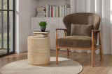 Briar Nettle accent chair in a reading corner beside bookshelves