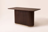 Brugnato counter height table in walnut, three-quarter view on a warm off-white backdrop