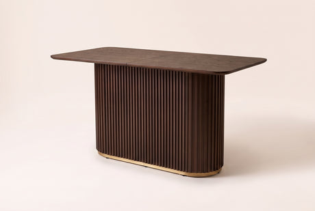 Brugnato counter height table in walnut, three-quarter view on a warm off-white backdrop
