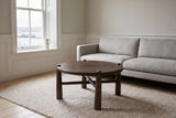 Buonconvento coffee table in dark walnut on an oatmeal wool rug in front of a light grey linen sofa in a Halifax row-house li