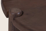Close-up of a Buonconvento leg passing up through a notch in the rounded edge of the top, its end grain showing
