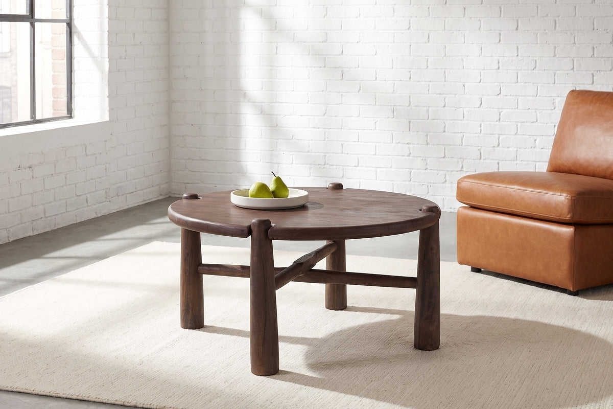 Buonconvento coffee table in dark walnut on a cream rug in a white-brick Montreal loft
