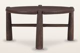 Buonconvento coffee table in dark walnut, front view: a thick round top, three of its four legs and a low stretcher
