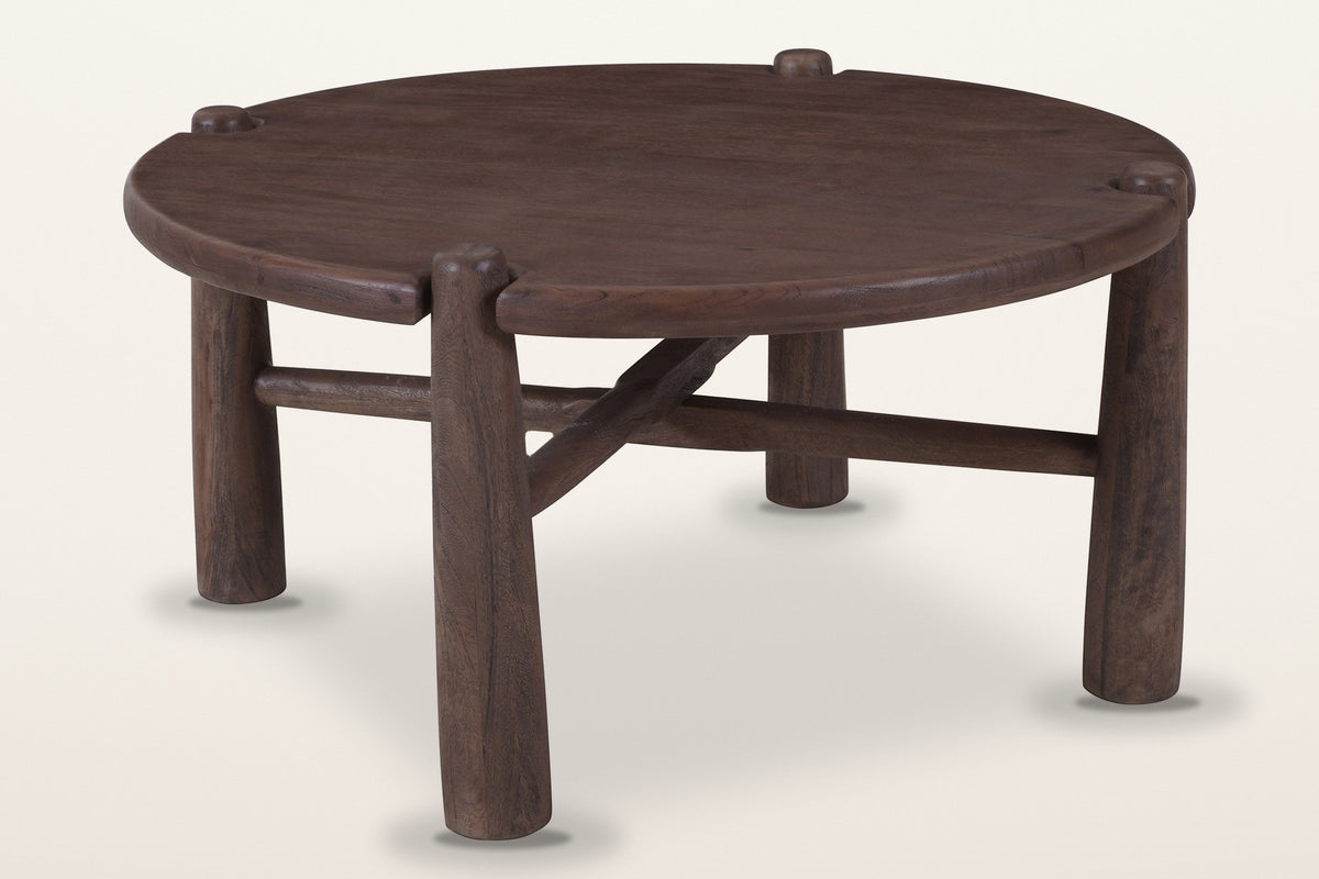 Buonconvento round mango wood coffee table in dark walnut, three-quarter view on a warm white studio backdrop