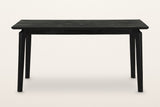 Calascio dining table in Black, front view on a warm white studio backdrop
