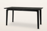Calascio splayed leg dining table in Black, three-quarter view on a warm white studio backdrop