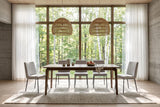 Calascio dining table in Brown in a Gatineau Hills forest house, with board-formed concrete, two woven pendants