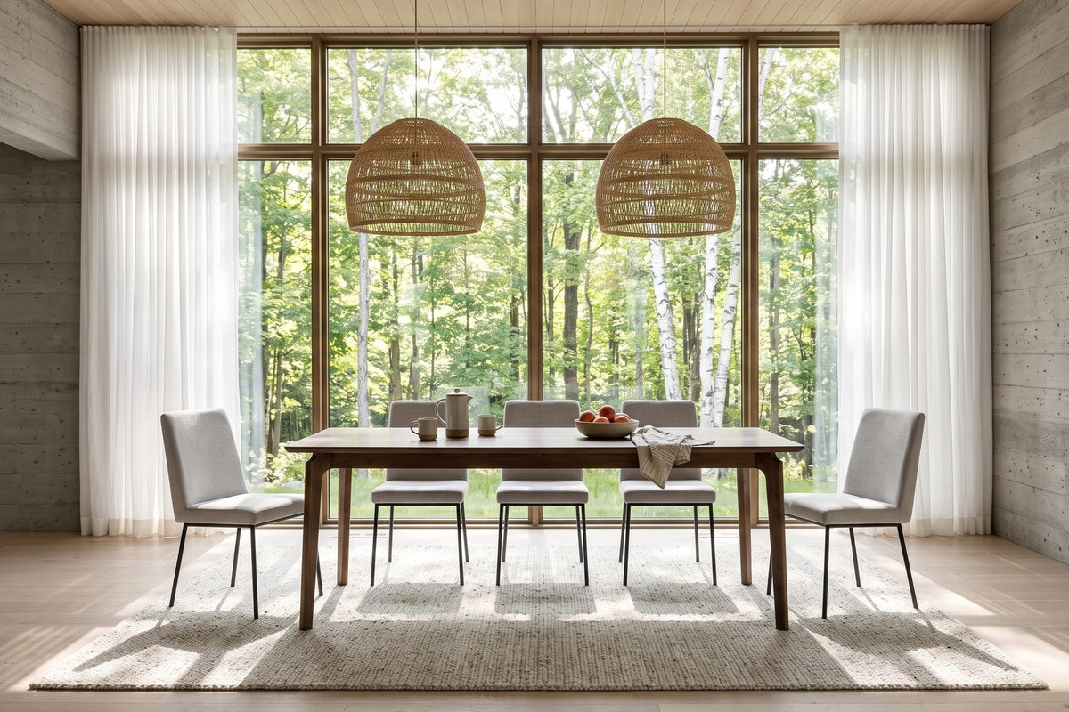 Calascio dining table in Brown in a Gatineau Hills forest house, with board-formed concrete, two woven pendants