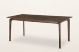 Calascio splayed leg dining table in Brown, three-quarter view on a warm white studio backdrop
