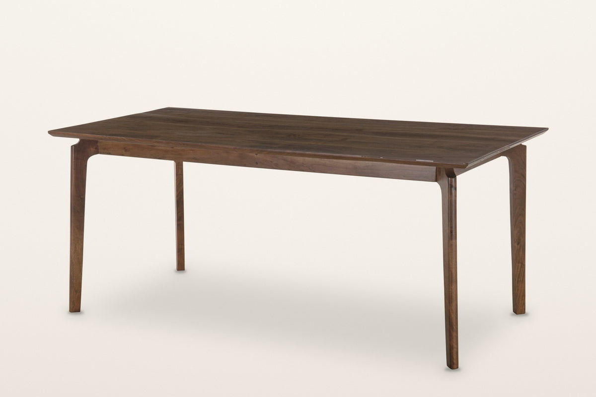 Calascio splayed leg dining table in Brown, three-quarter view on a warm white studio backdrop