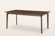 Calascio splayed leg dining table in Brown, three-quarter view on a warm white studio backdrop