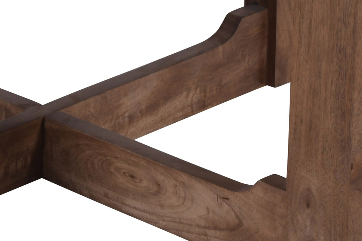 Close-up of the Calcata base: a plank leg, the cove-shaped step of a stretcher arm and the cross joint, walnut finish