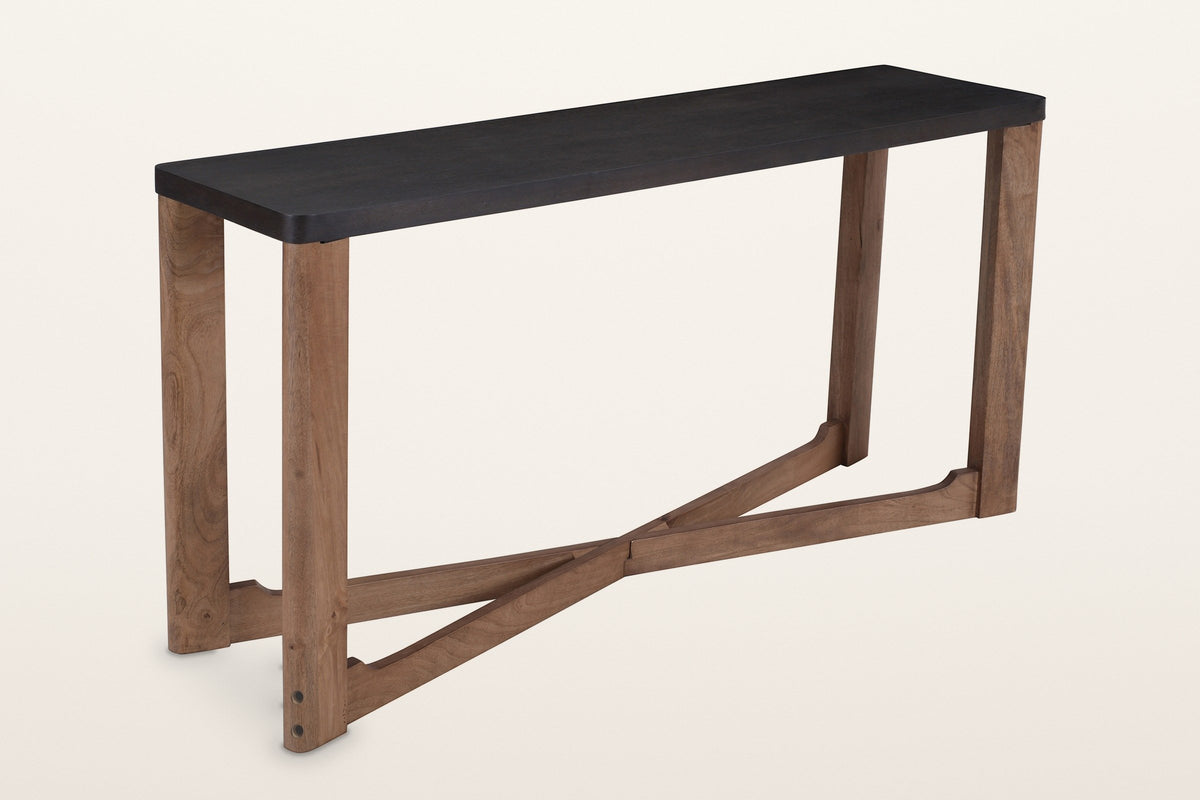 Calcata two-tone mango wood console table, a mocha top on a walnut base, three-quarter view on a warm white studio backdrop