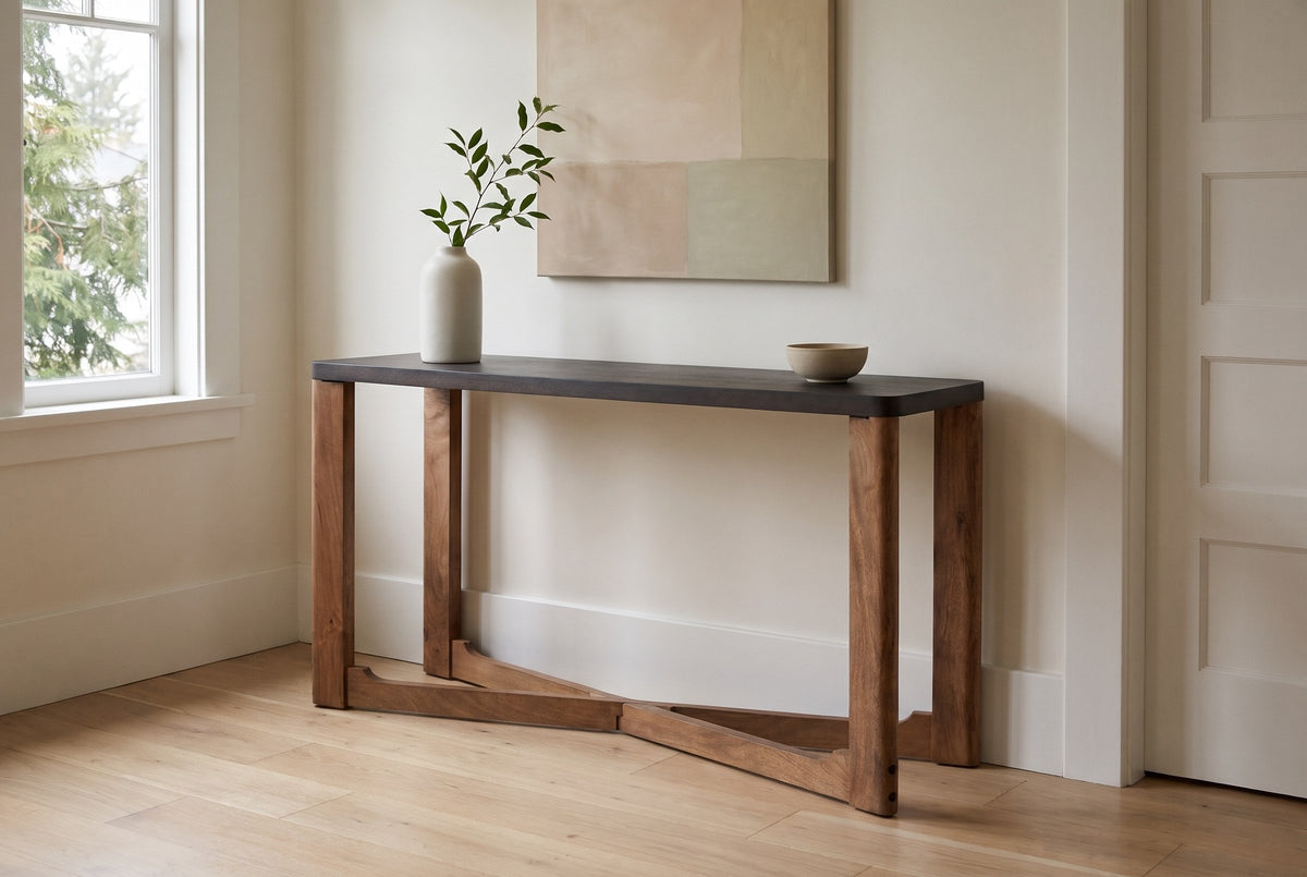 Calcata console table against a warm white plaster wall in a Kitsilano, Vancouver front hall, a green branch in a white vase and a sand stoneware bowl on the mocha top