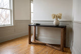 Calcata console table against a putty-grey wainscot in a Wolseley, Winnipeg entry hall, dried hydrangeas in a round cream vase on the mocha top