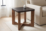 Calcata side table beside an oatmeal linen sofa in a Halifax living room, a small white vase with a dried grass stem on top