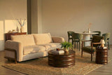 Calista Sand fabric sofa in a warm open-plan room next to a dining area