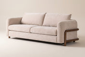 Calista sofa in Sand, three-quarter view on a warm off-white studio backdrop: rounded arms, two back and two seat cushions
