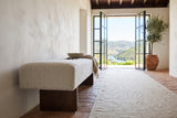 Caltagirone bench in Oatmeal Sand seen from the end along the wall of a Douro Valley quinta entry, lime plaster