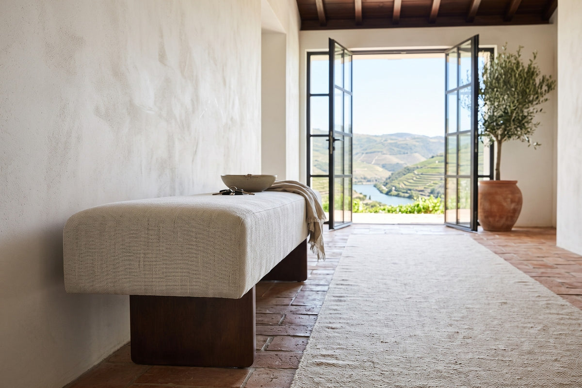 Caltagirone bench in Oatmeal Sand seen from the end along the wall of a Douro Valley quinta entry, lime plaster