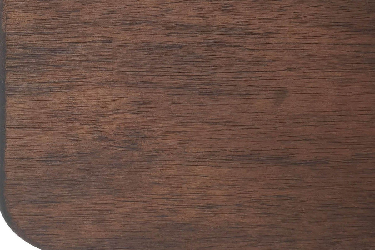 Close-up of a Caltagirone walnut slab leg: straight grain and a rounded lower corner