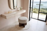 Caltagirone stool in Oatmeal Sand seen from above at a floating travertine vanity in a Lake Trasimeno villa