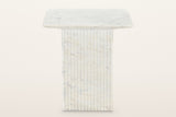 Camerota side table, straight front view: a thin square marble top on a fluted square marble pedestal