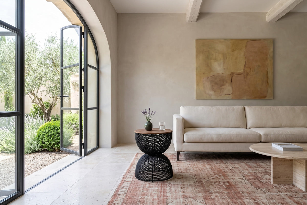 Canale side table in Black at the arm of a cream linen sofa in a Lourmarin bastide, with greige limewash