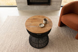 The Canale side table in Black seen from above beside a rust boucle lounge chair in a Pincher Creek ranch house