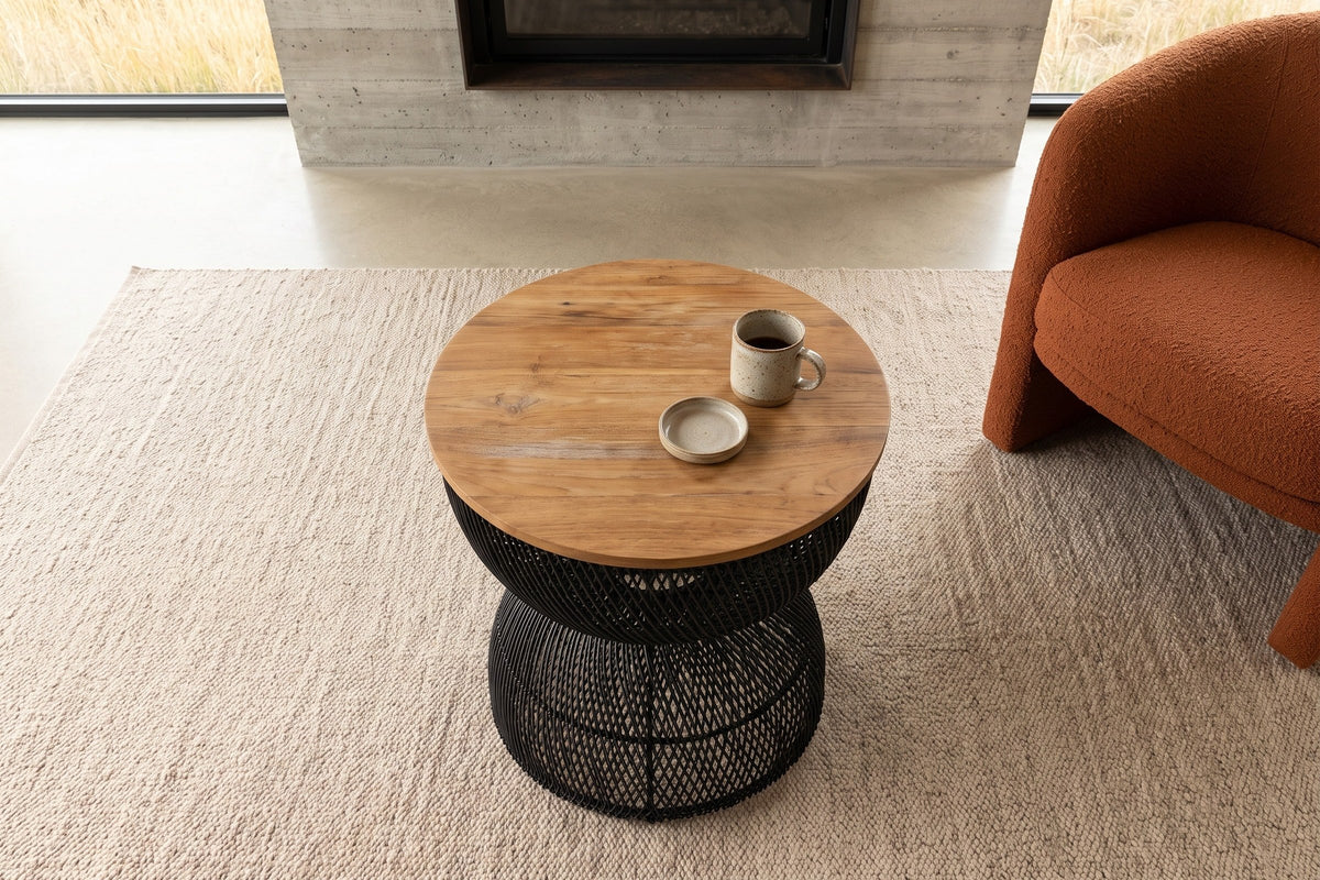 The Canale side table in Black seen from above beside a rust boucle lounge chair in a Pincher Creek ranch house
