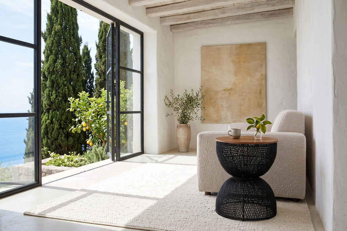 Canale side table in Black beside an oatmeal boucle sofa in a Ravello villa on the Amalfi Coast, with white lime plaster