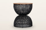 Canale rattan hourglass side table in Black on a warm white studio backdrop: a round teak top on an open-weave black rattan h
