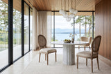 Two Candelo cane back dining chairs at a round fluted marble table in a Qualicum Beach house