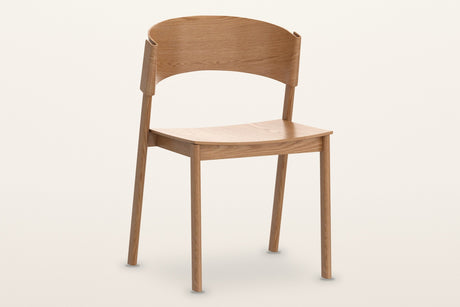 Canelli oak dining chair in natural, three-quarter view on a warm white studio backdrop
