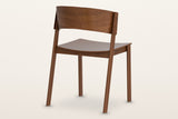 Canelli dining chair in walnut from behind: the curved back band, the two back posts and the seat rail