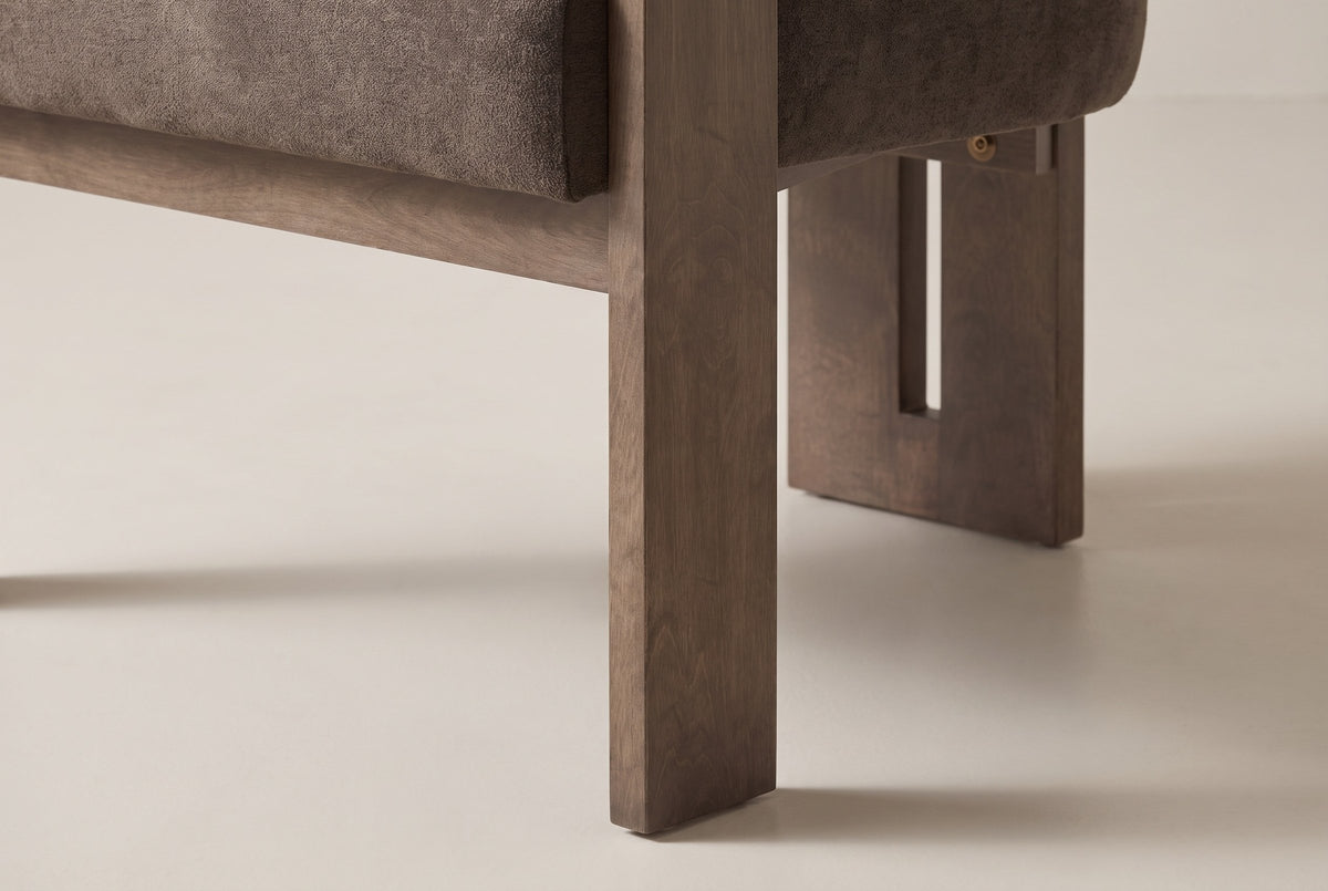 Close-up of a flat solid birch front leg in walnut stain and the slotted rear leg behind it