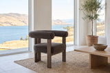 Caorle chair on a jute rug in a Kelowna lake house with tall windows onto the lake and hills