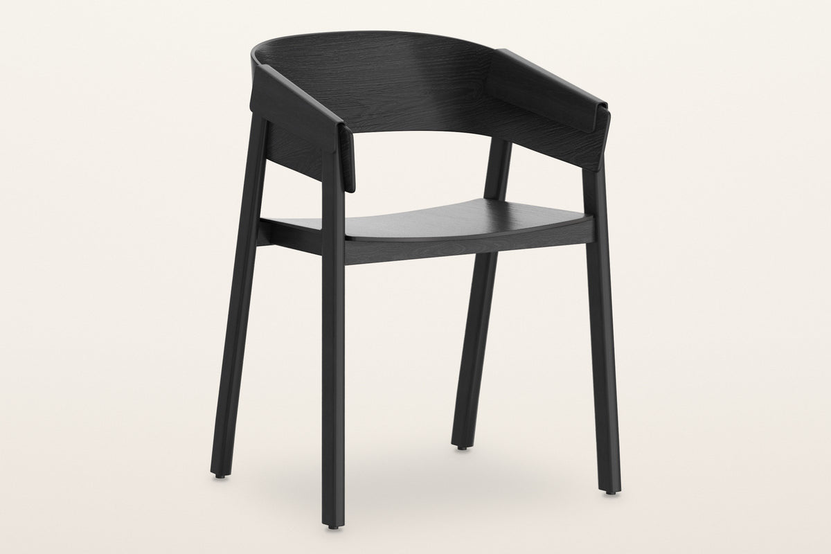 Caprarola dining armchair in black, three-quarter view on a warm white studio backdrop