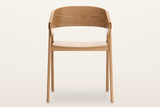 Caprarola dining armchair in natural oak, straight front view: the shell folding over both front legs