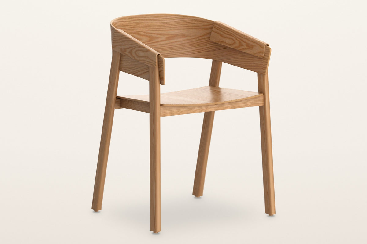 Caprarola dining armchair in natural oak, three-quarter view on a warm white studio backdrop