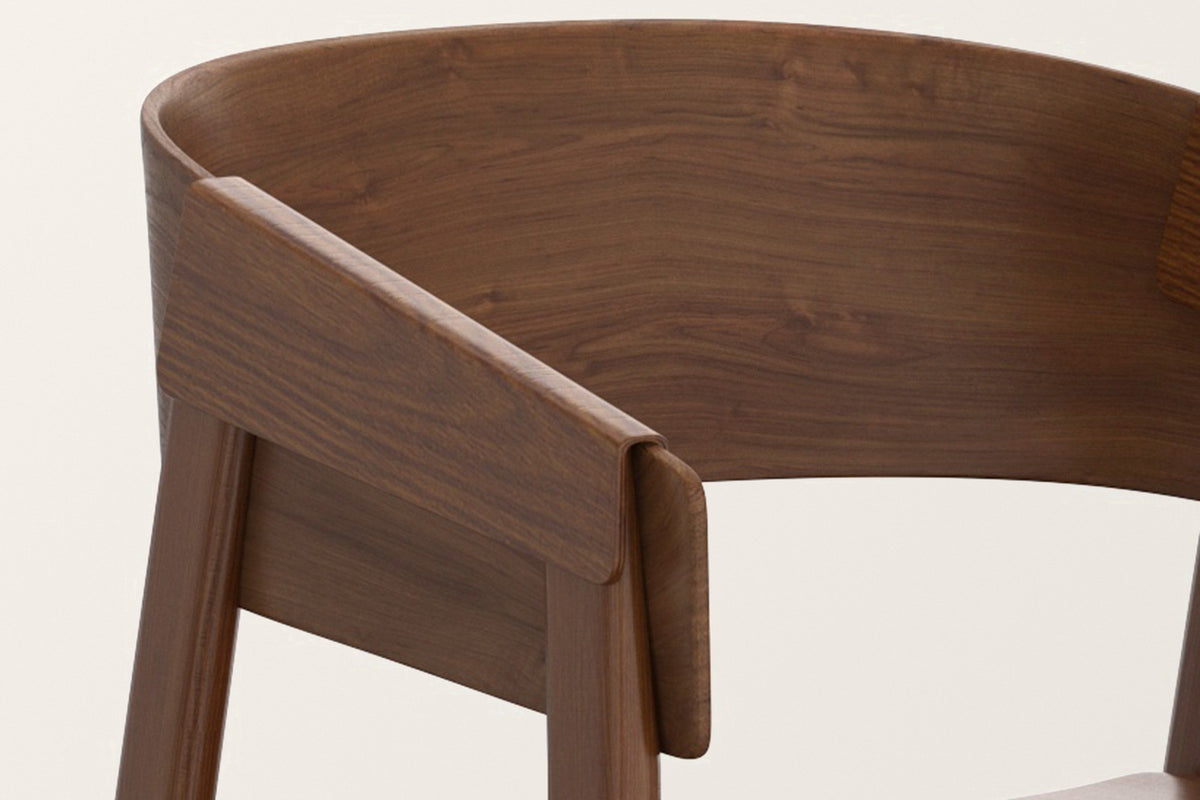 Close-up of the Caprarola arm in walnut: the bent back shell folding down over the top of the front leg