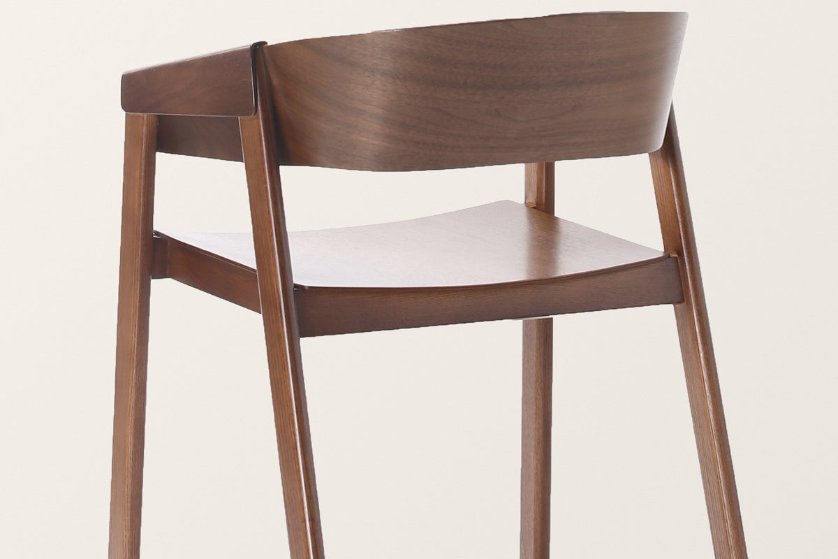 The Caprarola chair from behind in walnut: the back legs rake back and run up into the bent shell